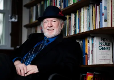Man leaning against a bookshelf